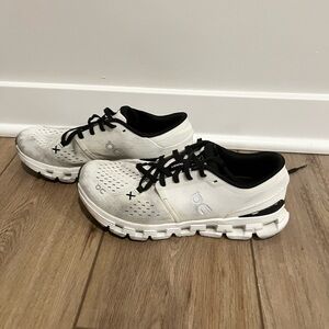 On Running White and Black Athletic Shoes